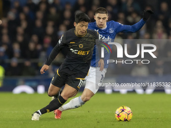 Hwang Hee-chan #11 of Wolverhampton Wanderers F.C. is tackled by Vitaliy Mykolenko #19 of Everton F.C. during the Premier League match betwe...