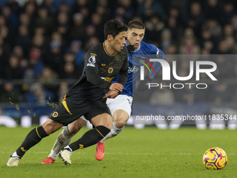 Hwang Hee-chan #11 of Wolverhampton Wanderers F.C. is tackled by Vitaliy Mykolenko #19 of Everton F.C. during the Premier League match betwe...