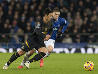 Hwang Hee-chan #11 of Wolverhampton Wanderers F.C. is tackled by Vitaliy Mykolenko #19 of Everton F.C. during the Premier League match betwe...