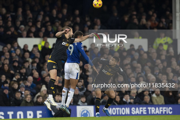 Dominic Calvert-Lewin #9 of Everton F.C. engages in an aerial challenge with an opponent during the Premier League match between Everton and...