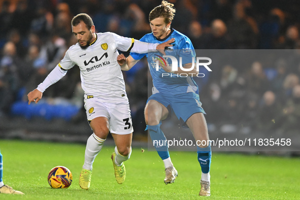 Mason Bennett (32 Burton Albion) is challenged by Oscar Wallin (5 Peterborough United) during the Sky Bet League 1 match between Peterboroug...