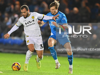 Mason Bennett (32 Burton Albion) is challenged by Oscar Wallin (5 Peterborough United) during the Sky Bet League 1 match between Peterboroug...