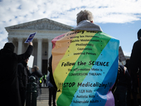 Sherrie Taha demonstrates against gender-affirming care for transgender children outside the Supreme Court in Washington, DC, on December 4,...