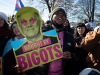 A demonstrator displays a sign accusing Supreme Court Justice Neil Gorsuch of corruption during a rally in support of gender-affirming care...