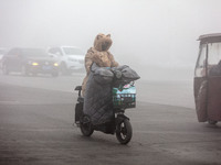 Cars travel in heavy fog with visibility of less than 100 meters on a street in Hua County, Anyang, China, on December 5, 2024. (