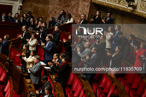 Deputies of the La France Insoumise group applaud the speech of Mathilde Feld during the session examining the report of the 2024 end-of-yea...