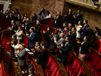 Deputies of the La France Insoumise group applaud the speech of Mathilde Feld during the session examining the report of the 2024 end-of-yea...