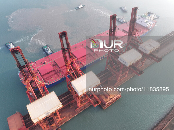 A Singapore-registered ship carrying 400,000 tons of iron ore is unloaded at a berth in Lianyungang port in Jiangsu province, China, on Dece...