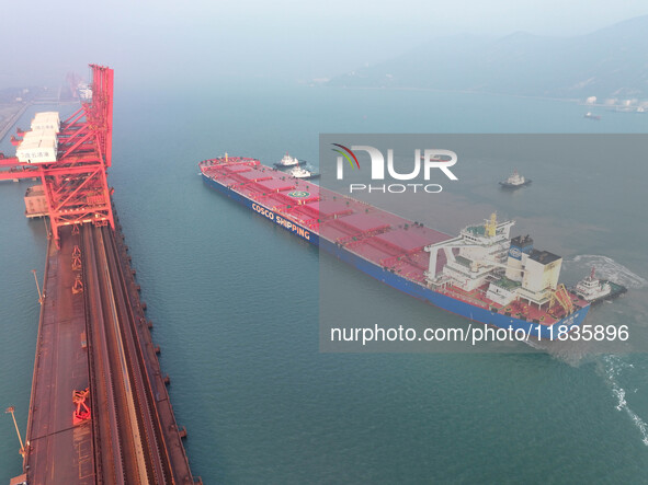 A Singapore-registered ship carrying 400,000 tons of iron ore is unloaded at a berth in Lianyungang port in Jiangsu province, China, on Dece...