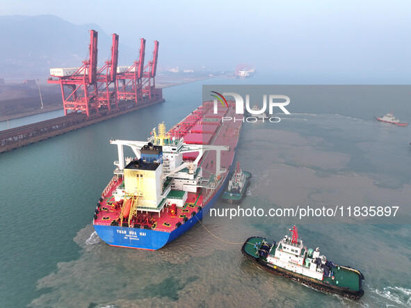 A Singapore-registered ship carrying 400,000 tons of iron ore is unloaded at a berth in Lianyungang port in Jiangsu province, China, on Dece...