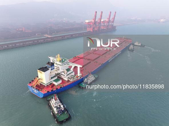 A Singapore-registered ship carrying 400,000 tons of iron ore is unloaded at a berth in Lianyungang port in Jiangsu province, China, on Dece...