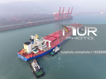 A Singapore-registered ship carrying 400,000 tons of iron ore is unloaded at a berth in Lianyungang port in Jiangsu province, China, on Dece...