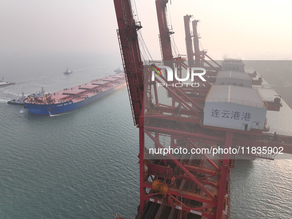 A Singapore-registered ship carrying 400,000 tons of iron ore is unloaded at a berth in Lianyungang port in Jiangsu province, China, on Dece...