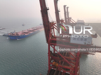 A Singapore-registered ship carrying 400,000 tons of iron ore is unloaded at a berth in Lianyungang port in Jiangsu province, China, on Dece...