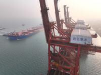 A Singapore-registered ship carrying 400,000 tons of iron ore is unloaded at a berth in Lianyungang port in Jiangsu province, China, on Dece...