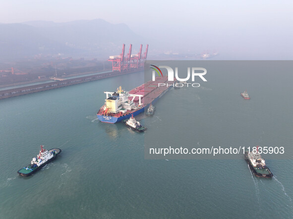 A Singapore-registered ship carrying 400,000 tons of iron ore is unloaded at a berth in Lianyungang port in Jiangsu province, China, on Dece...