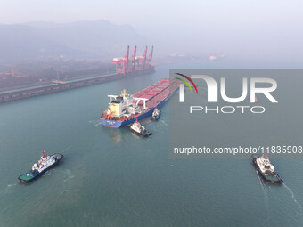 A Singapore-registered ship carrying 400,000 tons of iron ore is unloaded at a berth in Lianyungang port in Jiangsu province, China, on Dece...