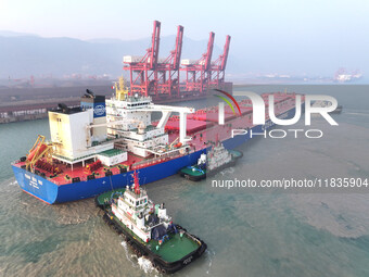 A Singapore-registered ship carrying 400,000 tons of iron ore is unloaded at a berth in Lianyungang port in Jiangsu province, China, on Dece...