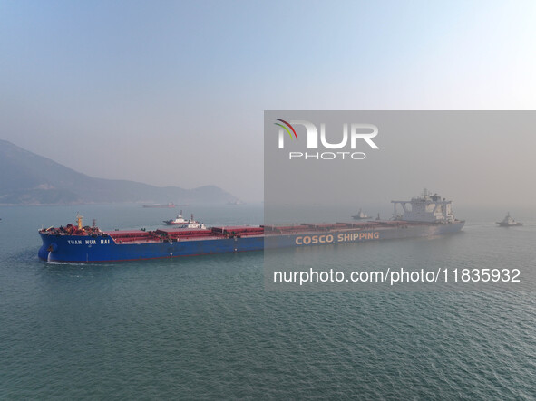 A Singapore-registered ship carrying 400,000 tons of iron ore is unloaded at a berth in Lianyungang port in Jiangsu province, China, on Dece...