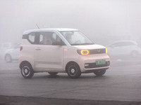 Cars operate in heavy fog with visibility of less than 100 meters on a street in Hua County, Anyang city, central China's Henan province, on...