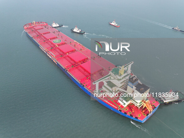 A Singapore-registered ship carrying 400,000 tons of iron ore is unloaded at a berth in Lianyungang port in Jiangsu province, China, on Dece...