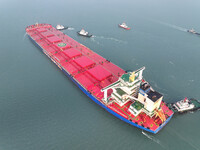 A Singapore-registered ship carrying 400,000 tons of iron ore is unloaded at a berth in Lianyungang port in Jiangsu province, China, on Dece...