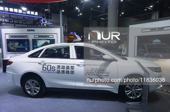 Visitors experience driving learning using a car instructor robot at the Zhejiang International Intelligent Transportation Industry Expo in...