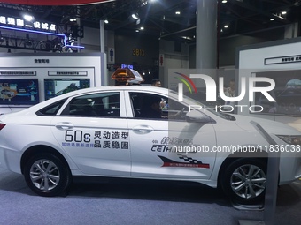 Visitors experience driving learning using a car instructor robot at the Zhejiang International Intelligent Transportation Industry Expo in...