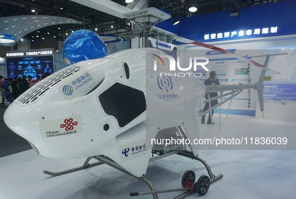 Visitors look at the Highland general purpose unmanned helicopter HY600 at the Zhejiang International Intelligent Transportation Industry Ex...