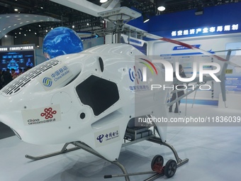 Visitors look at the Highland general purpose unmanned helicopter HY600 at the Zhejiang International Intelligent Transportation Industry Ex...