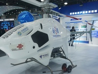 Visitors look at the Highland general purpose unmanned helicopter HY600 at the Zhejiang International Intelligent Transportation Industry Ex...