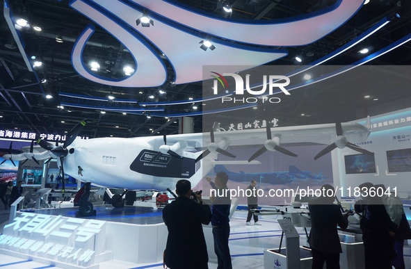 Visitors watch the super hybrid cargo drone ''Tianmushan III'' at the Zhejiang International Intelligent Transportation Industry Expo in Han...