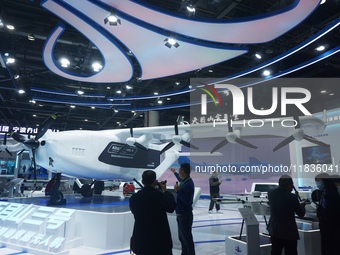 Visitors watch the super hybrid cargo drone ''Tianmushan III'' at the Zhejiang International Intelligent Transportation Industry Expo in Han...