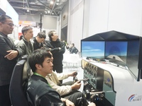 Visitors experience flying on a flight simulator at the Zhejiang International Intelligent Transportation Industry Expo in Hangzhou, China,...