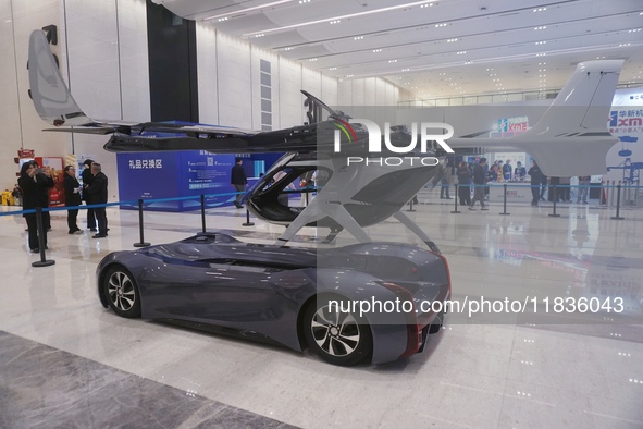 Visitors look at a Chery composite wing modular flying car at the Zhejiang International Intelligent Transportation Industry Expo in Hangzho...