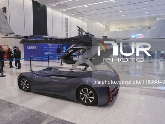 Visitors look at a Chery composite wing modular flying car at the Zhejiang International Intelligent Transportation Industry Expo in Hangzho...