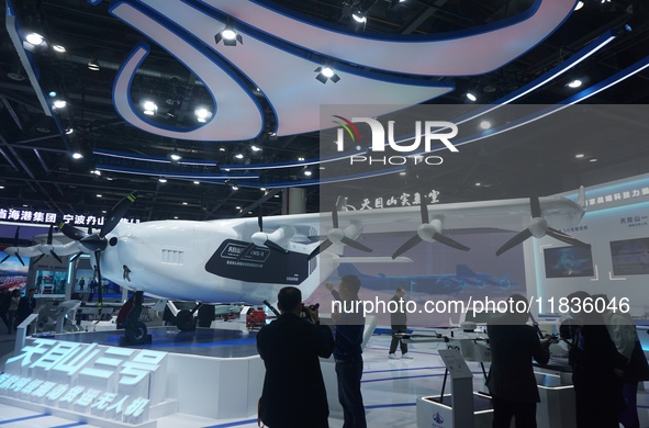 Visitors watch the world's first ton super hybrid cargo drone ''Tianmushan III'' at the Zhejiang International Intelligent Transportation In...