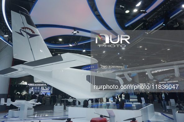 Visitors watch the world's first ton super hybrid cargo drone ''Tianmushan III'' at the Zhejiang International Intelligent Transportation In...