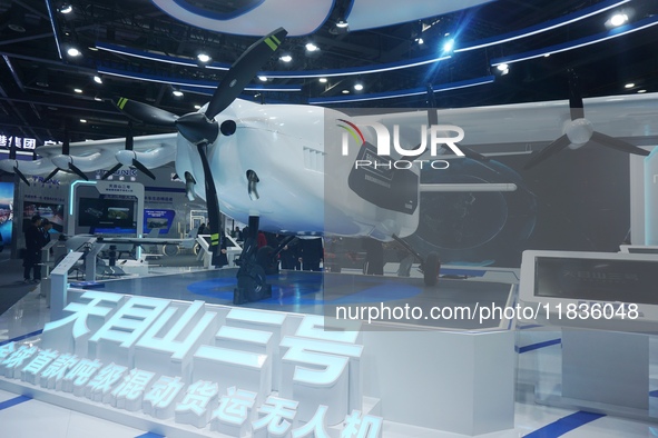 Visitors watch the world's first ton super hybrid cargo drone ''Tianmushan III'' at the Zhejiang International Intelligent Transportation In...