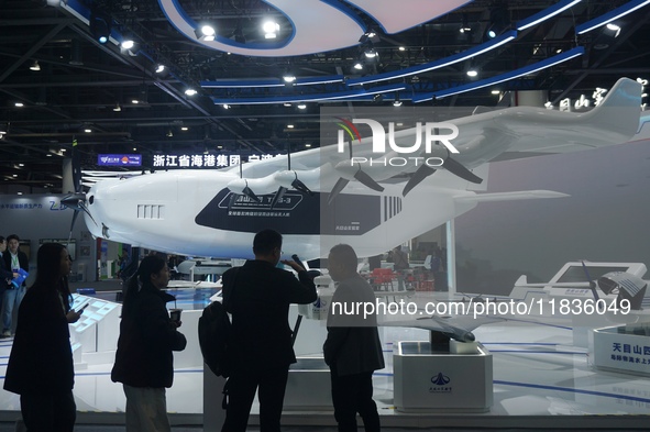 Visitors watch the world's first ton super hybrid cargo drone ''Tianmushan III'' at the Zhejiang International Intelligent Transportation In...