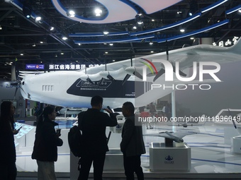 Visitors watch the world's first ton super hybrid cargo drone ''Tianmushan III'' at the Zhejiang International Intelligent Transportation In...