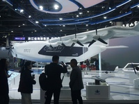 Visitors watch the world's first ton super hybrid cargo drone ''Tianmushan III'' at the Zhejiang International Intelligent Transportation In...