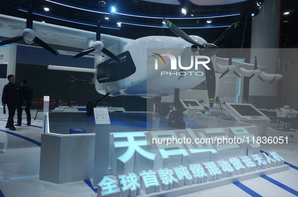 Visitors watch the world's first ton super hybrid cargo drone ''Tianmushan III'' at the Zhejiang International Intelligent Transportation In...