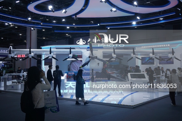 Visitors watch the world's first ton super hybrid cargo drone ''Tianmushan III'' at the Zhejiang International Intelligent Transportation In...