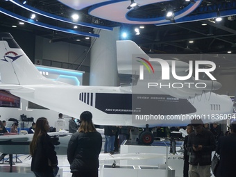 Visitors watch the world's first ton super hybrid cargo drone ''Tianmushan III'' at the Zhejiang International Intelligent Transportation In...