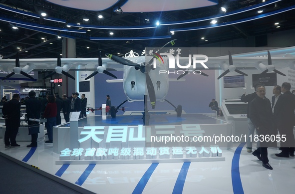 Visitors watch the world's first ton super hybrid cargo drone ''Tianmushan III'' at the Zhejiang International Intelligent Transportation In...