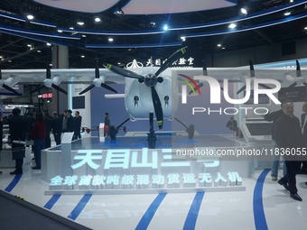 Visitors watch the world's first ton super hybrid cargo drone ''Tianmushan III'' at the Zhejiang International Intelligent Transportation In...