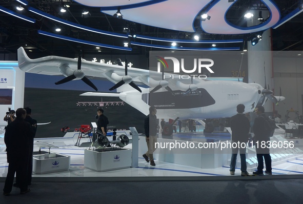 Visitors watch the world's first ton super hybrid cargo drone ''Tianmushan III'' at the Zhejiang International Intelligent Transportation In...