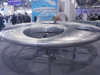 Visitors look at a manned flying saucer electric vertical take-off and landing (eVTOL) at the Zhejiang International Intelligent Transportat...