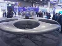 Visitors look at a manned flying saucer electric vertical take-off and landing (eVTOL) at the Zhejiang International Intelligent Transportat...